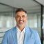 Smiling 50 years old professional business man ceo investor in blue suit standing in office, happy confident older businessman corporate leader executive looking at camera at work, headshot portrait.